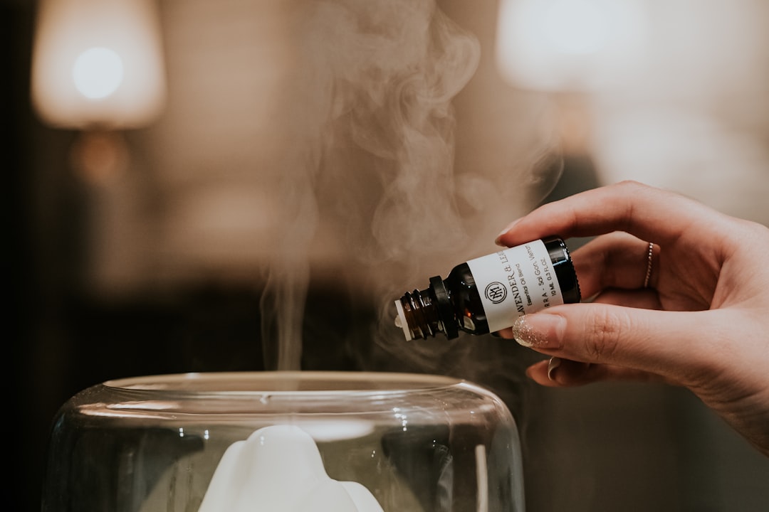 Lavender essential oil being put into a diffuser