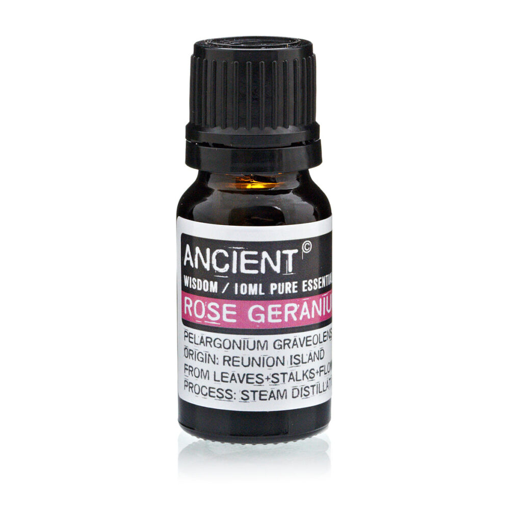 Small dark bottle of rose geranium essential oil with a black ribbed cap and white label.