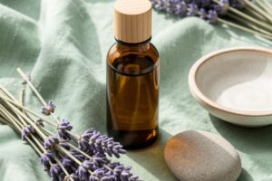 Lavender on a table with Lavender Essential Oil in a brown bottle